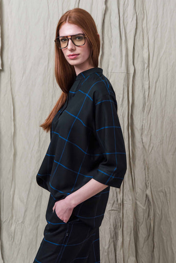 EVA IS WEARING A BLUE PLAID SHIRT